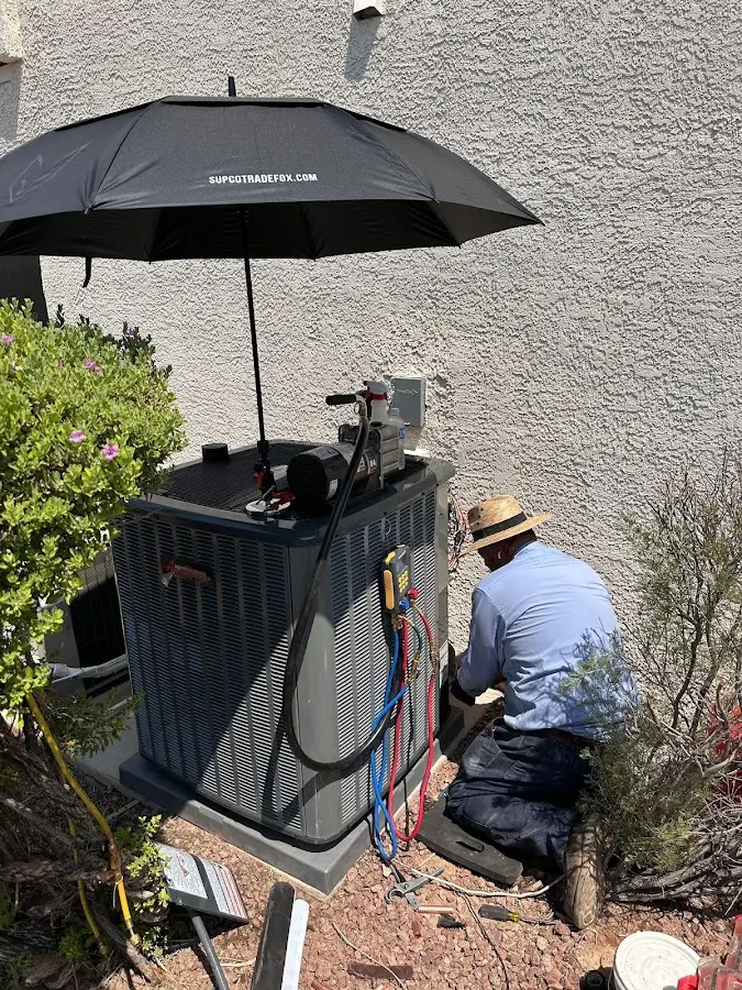 HVAC technician performing outdoor AC maintenance in New Kensington