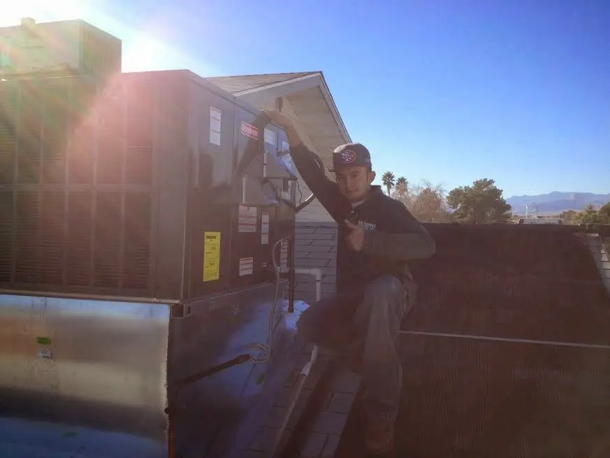 HVAC technician performing HVAC Inspection on a rooftop unit in New Kensington